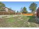 Level backyard with ample grassy space and a wooden fence providing privacy at 5987 S Pierson St, Littleton, CO 80127