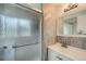 Well-lit bathroom featuring a frosted glass shower, modern sink, and tasteful tile work at 5987 S Pierson St, Littleton, CO 80127