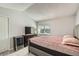 Inviting bedroom with an entertainment center and storage, offering a blend of relaxation and functionality at 5987 S Pierson St, Littleton, CO 80127