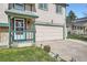 A quaint home featuring stone accents, a covered entrance, and attached garage at 5987 S Pierson St, Littleton, CO 80127