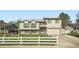 Two-story home featuring well-maintained landscaping and a white picket fence at 5987 S Pierson St, Littleton, CO 80127