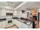 Modern kitchen featuring white cabinets and stainless steel appliances at 5987 S Pierson St, Littleton, CO 80127