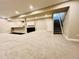 Spacious finished basement with a bar area, stairs and neutral carpet at 9032 Middle Fork St, Littleton, CO 80125