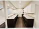 Finished basement with a wet bar featuring granite countertops and dark wood cabinets at 9032 Middle Fork St, Littleton, CO 80125