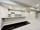 Finished basement bar area featuring granite counters and white cabinets at 9032 Middle Fork St, Littleton, CO 80125