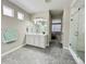 Bathroom featuring a vanity, glass enclosed shower and gray hexagon tile flooring at 9032 Middle Fork St, Littleton, CO 80125