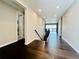 Hallway with hardwood floors provides a seamless transition between rooms, leading to a bright and airy living space at 9032 Middle Fork St, Littleton, CO 80125