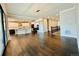 Bright and airy living space with hardwood floors, a modern light fixture, and an open kitchen layout at 9032 Middle Fork St, Littleton, CO 80125