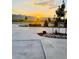 Scenic street view at sunset, showcasing well-maintained landscaping and the tranquil beauty of the surrounding mountains at 9032 Middle Fork St, Littleton, CO 80125