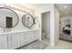 Bright bathroom with a double sink, modern fixtures, and access to the Primary bedroom at 9855 Chatswood Trl, Highlands Ranch, CO 80126