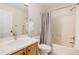 Classic bathroom featuring a vanity with a marble countertop and a shower-tub with a gray curtain at 9855 Chatswood Trl, Highlands Ranch, CO 80126