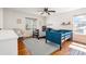 Charming bedroom featuring hardwood floors, twin beds, and large windows at 9855 Chatswood Trl, Highlands Ranch, CO 80126