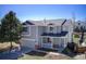 Charming two-story home featuring a cozy front porch, attached garage, and manicured lawn at 9855 Chatswood Trl, Highlands Ranch, CO 80126
