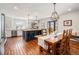 Modern kitchen with white cabinets, a large island, and stainless steel appliances, flowing into the dining area at 9855 Chatswood Trl, Highlands Ranch, CO 80126