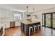 Stylish kitchen island with barstool seating, pendant lighting, and modern white cabinets and countertops at 9855 Chatswood Trl, Highlands Ranch, CO 80126