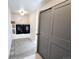 A modern laundry room with gray sliding doors and black washer dryer units and shelving at 9855 Chatswood Trl, Highlands Ranch, CO 80126