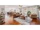 Spacious living room featuring hardwood floors, natural light, and an open layout to the kitchen and dining area at 9855 Chatswood Trl, Highlands Ranch, CO 80126