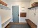 Inviting mudroom featuring built-in shelving, hooks, a wooden bench, and stylish decor at 9855 Chatswood Trl, Highlands Ranch, CO 80126