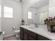 Clean bathroom with single vanity, shower/tub combo, and window at 15501 E 112Th Ave # 6F, Commerce City, CO 80022