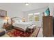 Bright bedroom with double bed, window, and wooden furniture at 15501 E 112Th Ave # 6F, Commerce City, CO 80022