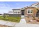Modern two-story home with stone accents and landscaped front yard at 15501 E 112Th Ave # 6F, Commerce City, CO 80022