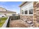 Small front patio with brick pavers and two pink chairs at 15501 E 112Th Ave # 6F, Commerce City, CO 80022