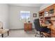 Home office with built-in wooden desk and shelving at 15501 E 112Th Ave # 6F, Commerce City, CO 80022