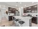 Modern kitchen with dark cabinetry, white countertops, and an island at 15501 E 112Th Ave # 6F, Commerce City, CO 80022