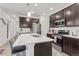 Modern kitchen with dark cabinets and a large island at 15501 E 112Th Ave # 6F, Commerce City, CO 80022