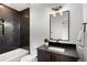 Modern bathroom with dark tile, a soaking tub, and floating vanity at 1838 Pearl # C, Boulder, CO 80302