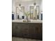 Double vanity bathroom with dark wood cabinets, white hexagon tile, and modern fixtures at 1838 Pearl # C, Boulder, CO 80302