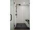 Spa-like shower with black hexagon floor tile, white subway tile, and built-in bench at 1838 Pearl # C, Boulder, CO 80302