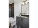 Stylish bathroom with dark wood vanity, black and white tile, and a single sink at 1838 Pearl # C, Boulder, CO 80302