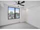 Charming bedroom with large window offering city views and ceiling fan at 1838 Pearl # C, Boulder, CO 80302