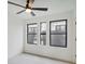 Spacious bedroom with three large windows, ceiling fan, and neutral color palette at 1838 Pearl # C, Boulder, CO 80302