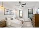 Bright bedroom with a queen-size bed, wooden dresser, and ceiling fan at 1838 Pearl # C, Boulder, CO 80302