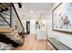 Light and airy entryway with hardwood floors and a modern staircase at 1838 Pearl # C, Boulder, CO 80302