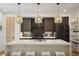Modern kitchen with dark cabinetry, white countertops, and stylish pendant lighting at 1838 Pearl # C, Boulder, CO 80302