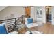 Cozy sitting area with two armchairs, a glass-top table, and a view of the staircase at 1838 Pearl # C, Boulder, CO 80302