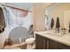 Well-lit bathroom featuring a modern vanity, contemporary fixtures, and a shower with a unique shower curtain at 3361 Mariposa St, Denver, CO 80211