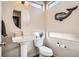 Stylish half-bathroom featuring a pedestal sink, modern fixtures, and unique decorative elements at 3361 Mariposa St, Denver, CO 80211