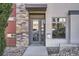 Inviting front entrance showcasing a modern door, stylish stonework, and well-maintained landscaping at 3361 Mariposa St, Denver, CO 80211