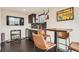 Cozy kitchenette area with sleek cabinetry, a beverage cooler, and a mounted TV for entertainment at 3361 Mariposa St, Denver, CO 80211