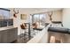 Stylish kitchenette featuring sleek cabinets, a sink, and a table with seating for four guests at 3361 Mariposa St, Denver, CO 80211