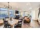 Open-concept living room and dining area featuring modern lighting, neutral tones, and large windows for ample natural light at 3361 Mariposa St, Denver, CO 80211