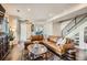 Comfortable living room featuring a leather sofa, patterned rug, and staircase at 3361 Mariposa St, Denver, CO 80211