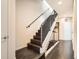 Modern staircase with dark wood steps and metal railings, leading to the upper level of the home at 3361 Mariposa St, Denver, CO 80211