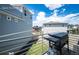 Back porch with a grill overlooking neighborhood homes on a sunny day with cloudy skies at 4443 N Quatar Ct, Aurora, CO 80019