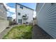 View of the back of the house with a grassy yard and gravel area, and a small balcony at 4443 N Quatar Ct, Aurora, CO 80019