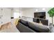 Finished basement area featuring a comfortable seating area with a large TV and neutral carpeting at 4443 N Quatar Ct, Aurora, CO 80019